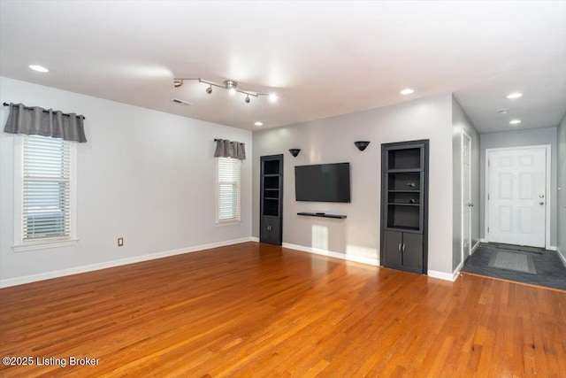 unfurnished living room with hardwood / wood-style floors