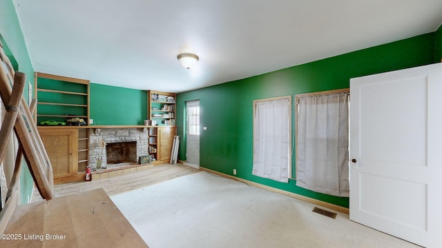 unfurnished living room featuring a fireplace