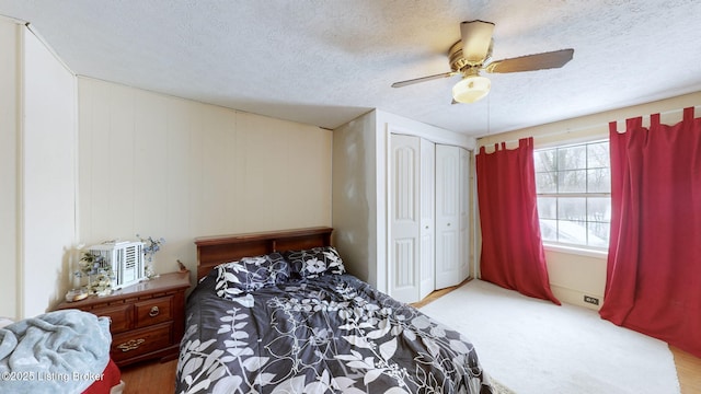 bedroom with a textured ceiling, ceiling fan, and a closet