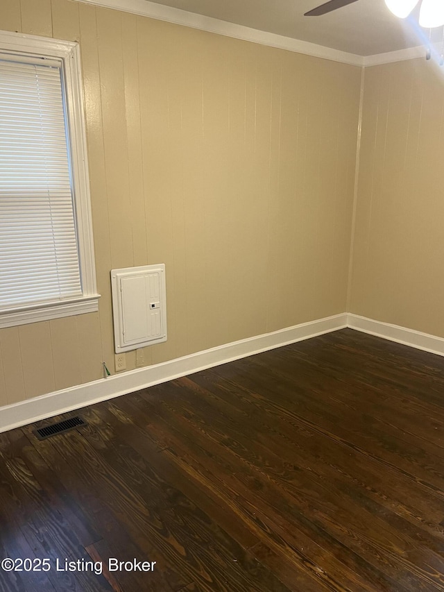 empty room with ceiling fan, crown molding, and dark hardwood / wood-style flooring