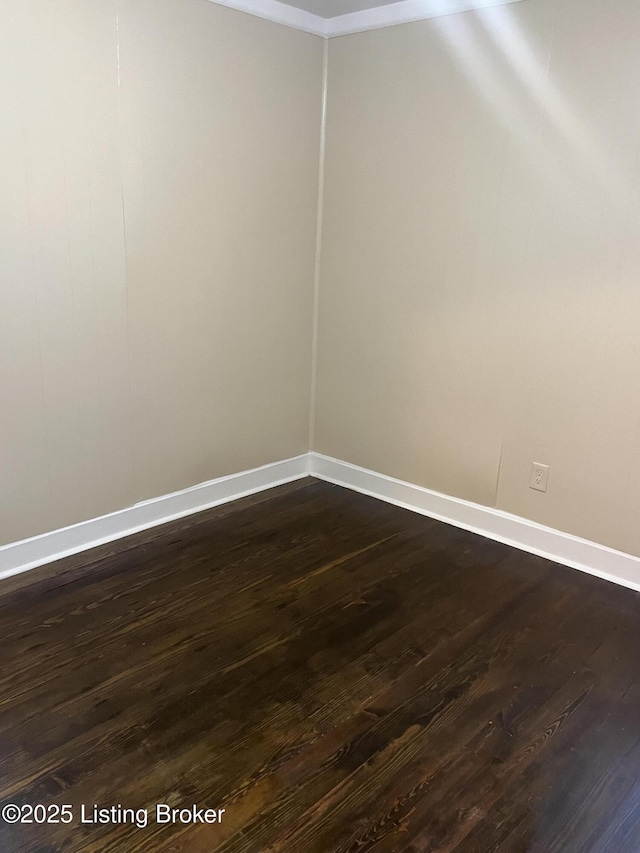 empty room with dark hardwood / wood-style floors