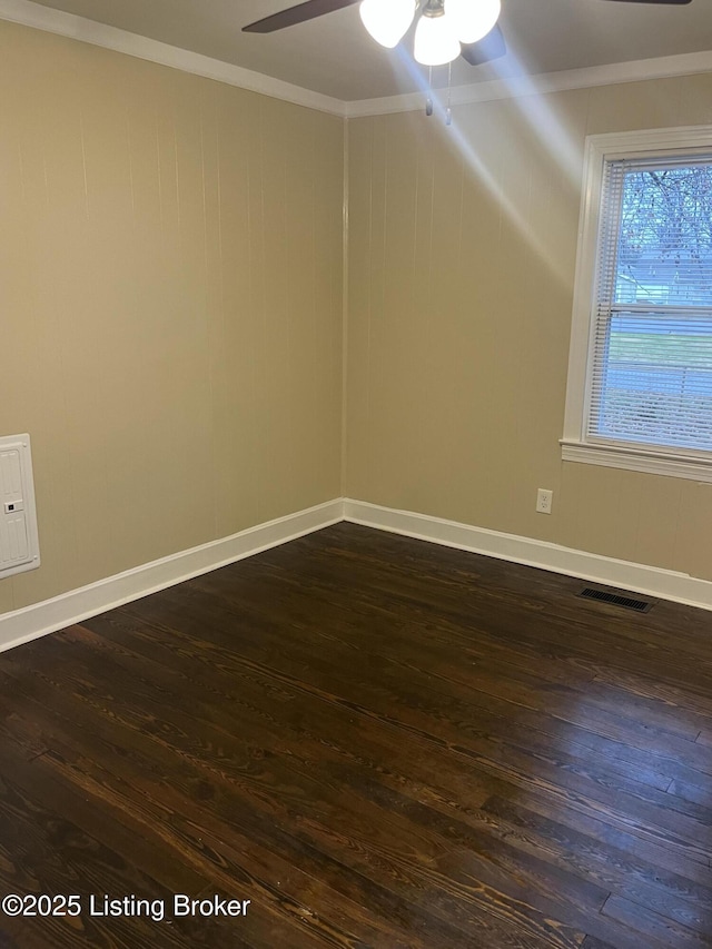 spare room with crown molding, dark hardwood / wood-style floors, and ceiling fan