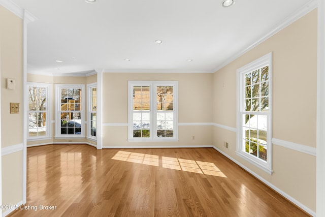 empty room featuring light hardwood / wood-style flooring and crown molding