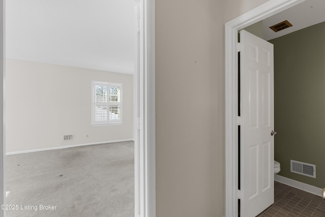 corridor featuring dark colored carpet