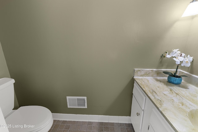 bathroom featuring toilet and vanity