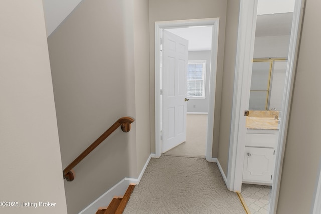 hallway featuring light carpet