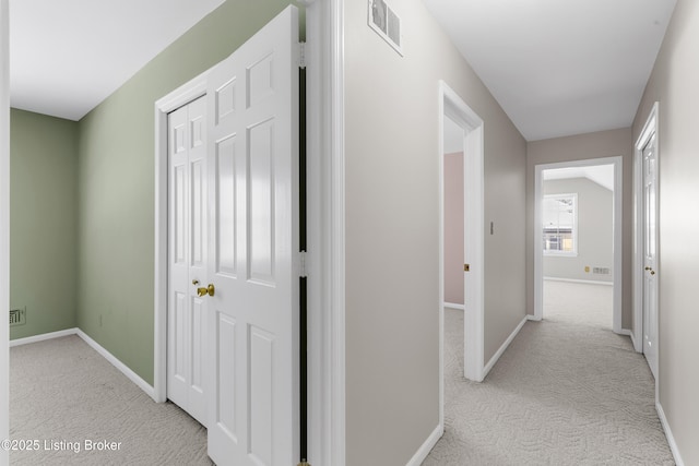 hallway featuring light colored carpet