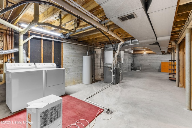 basement with heating unit, water heater, and washer and dryer