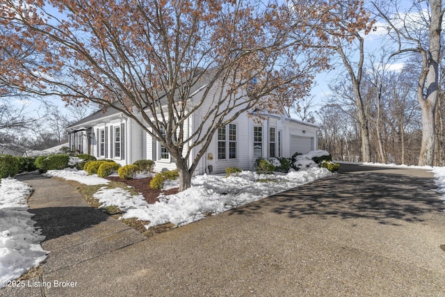 view of snow covered exterior with a garage