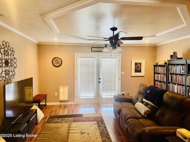 living room with light hardwood / wood-style floors, ceiling fan, french doors, and crown molding