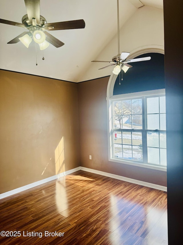 empty room featuring lofted ceiling and hardwood / wood-style flooring