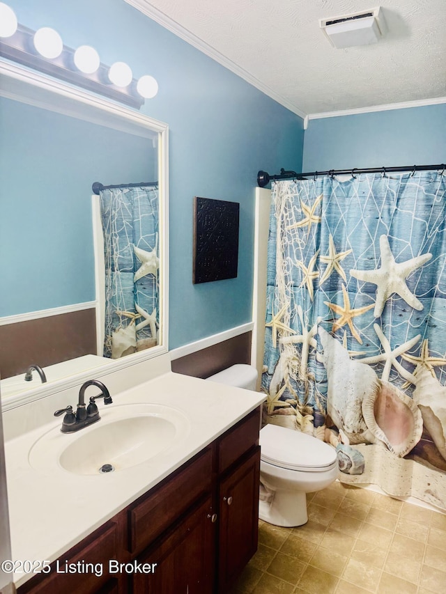 bathroom with toilet, walk in shower, vanity, ornamental molding, and a textured ceiling