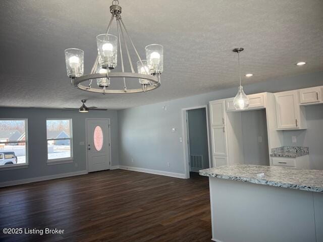 kitchen featuring white cabinetry, ceiling fan, dark wood-type flooring, a textured ceiling, and pendant lighting