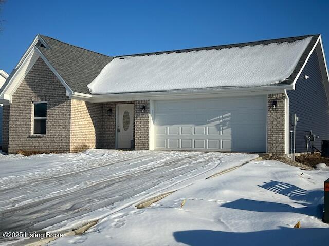 view of front of home with cooling unit and a garage