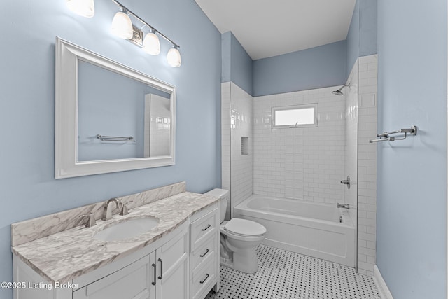 full bathroom featuring toilet, vanity, and tiled shower / bath