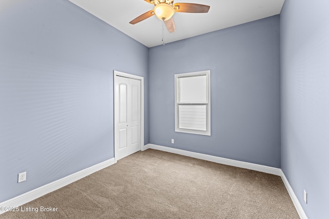 empty room featuring ceiling fan and carpet flooring