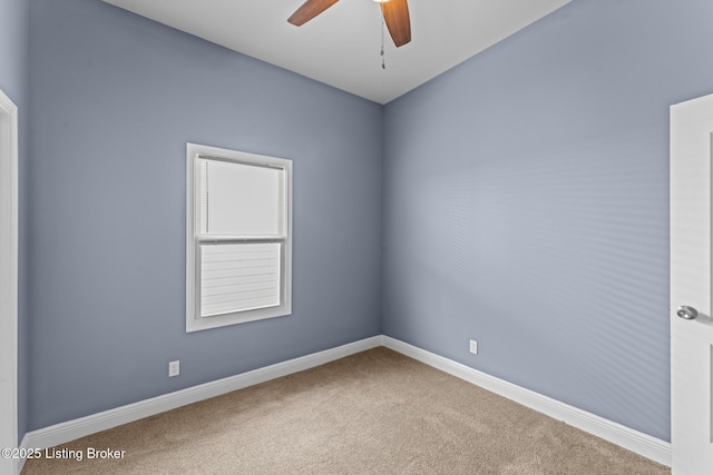 carpeted spare room with ceiling fan