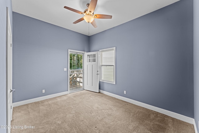 carpeted empty room featuring ceiling fan