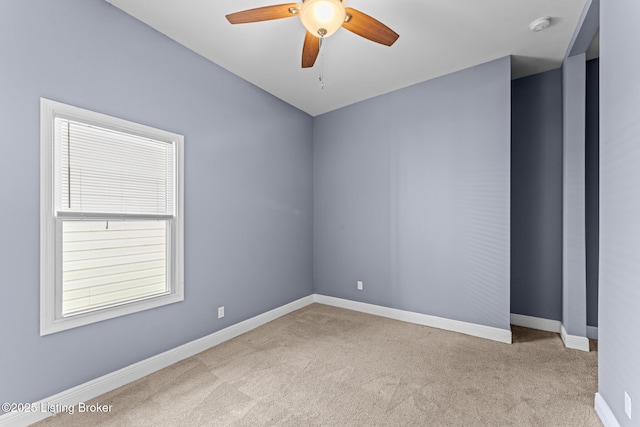 carpeted empty room featuring ceiling fan