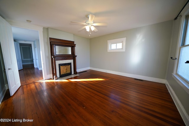 unfurnished living room with ceiling fan and dark hardwood / wood-style flooring