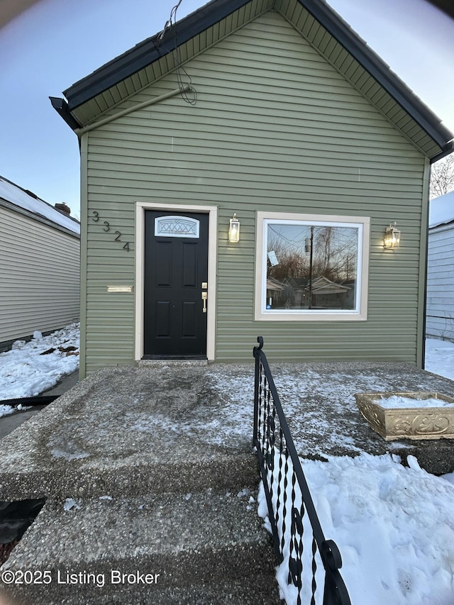 view of snow covered property entrance