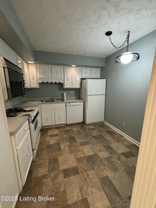 kitchen with pendant lighting, sink, white appliances, a textured ceiling, and white cabinets