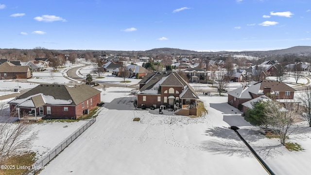 snowy aerial view featuring a mountain view