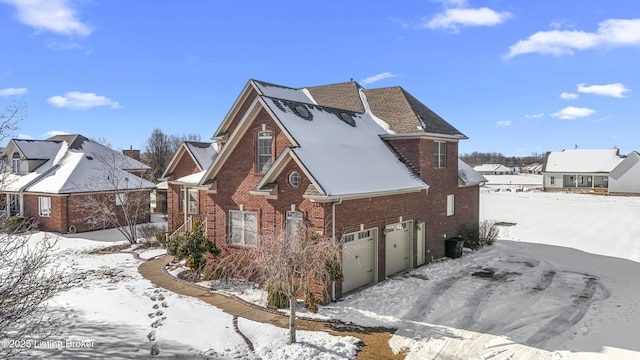 view of snowy exterior with a garage