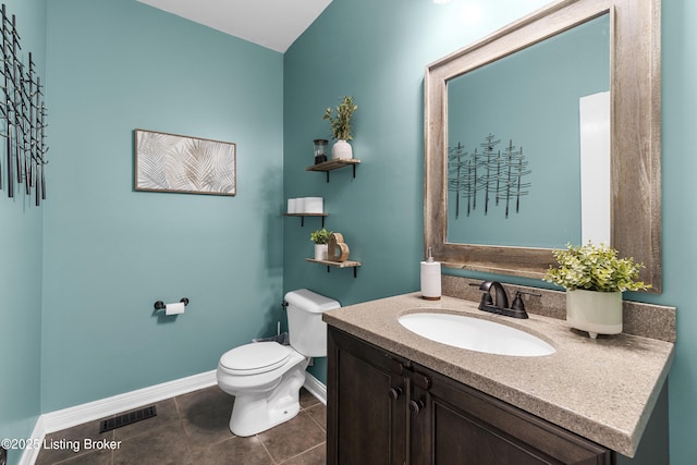 bathroom featuring tile patterned floors, toilet, and vanity