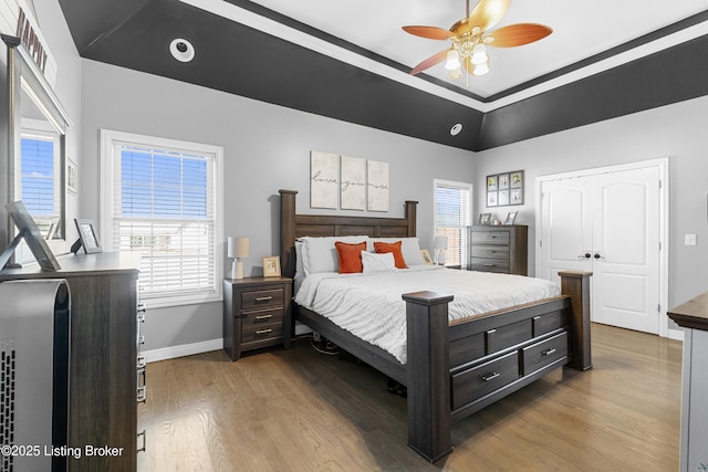 bedroom featuring ceiling fan, wood-type flooring, and ornamental molding