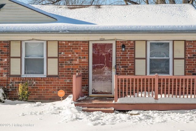 view of snow covered property entrance