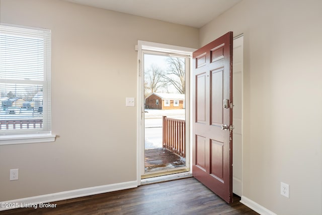 entrance foyer featuring dark wood-type flooring and a wealth of natural light