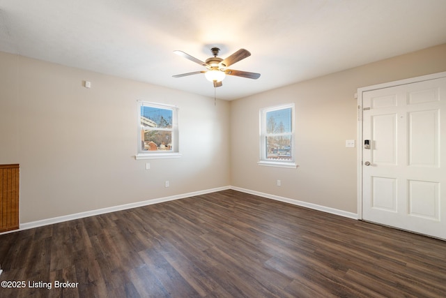 empty room featuring dark wood-type flooring and ceiling fan