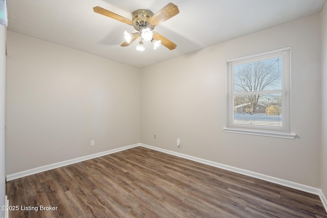 empty room featuring ceiling fan and dark hardwood / wood-style flooring