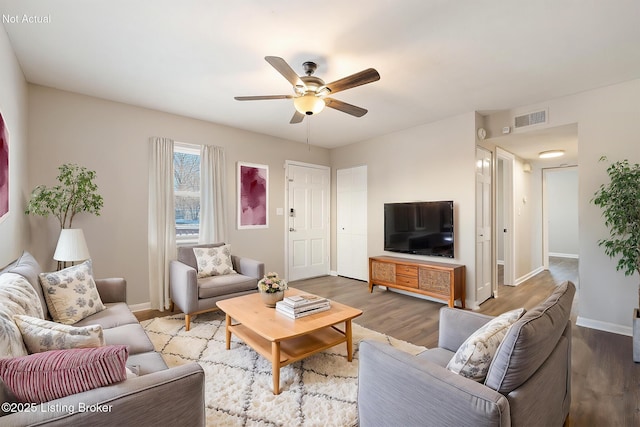 living room with ceiling fan and hardwood / wood-style floors