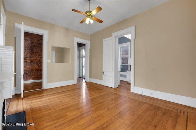 unfurnished room with ceiling fan and light wood-type flooring