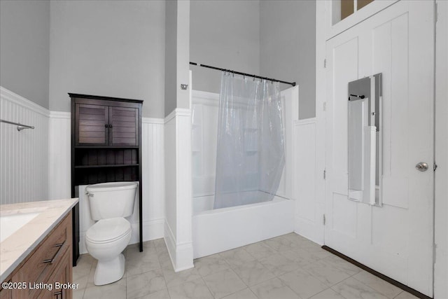 full bathroom with vanity, shower / tub combo with curtain, and toilet