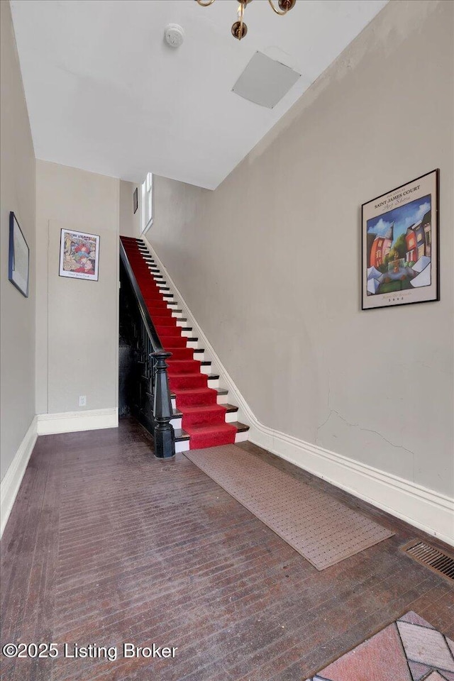 stairs featuring hardwood / wood-style floors