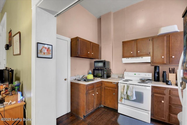 kitchen with dark hardwood / wood-style flooring, sink, white electric stove, and a high ceiling