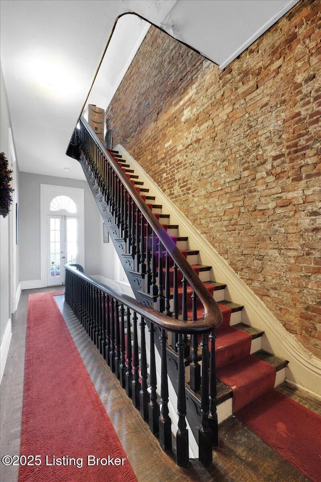 stairs featuring brick wall