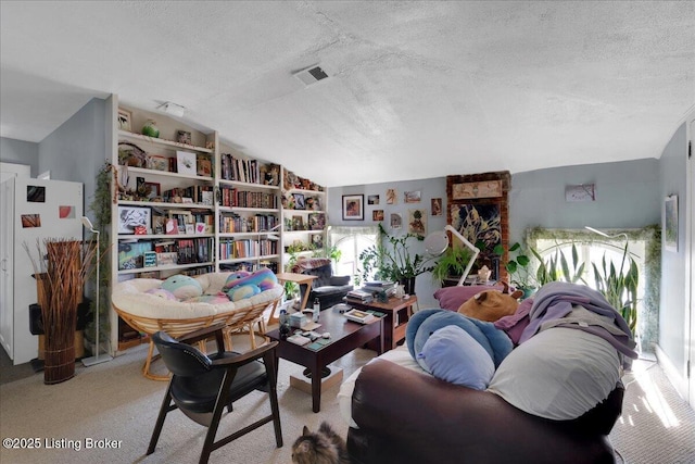 sitting room with light colored carpet, lofted ceiling, and a textured ceiling