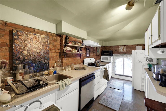 kitchen with stainless steel dishwasher, brick wall, range, and white cabinets