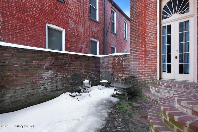 snow covered patio with french doors