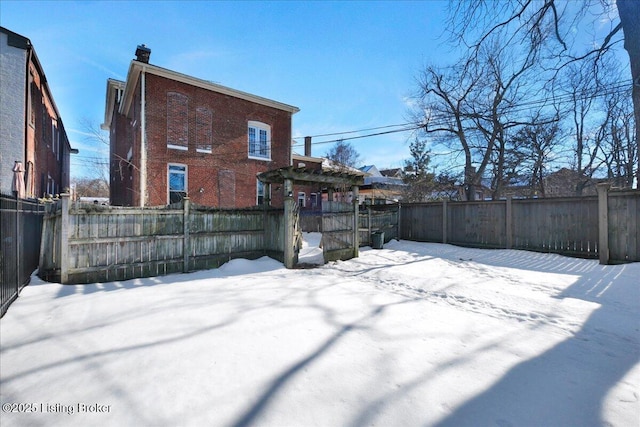 view of snow covered rear of property