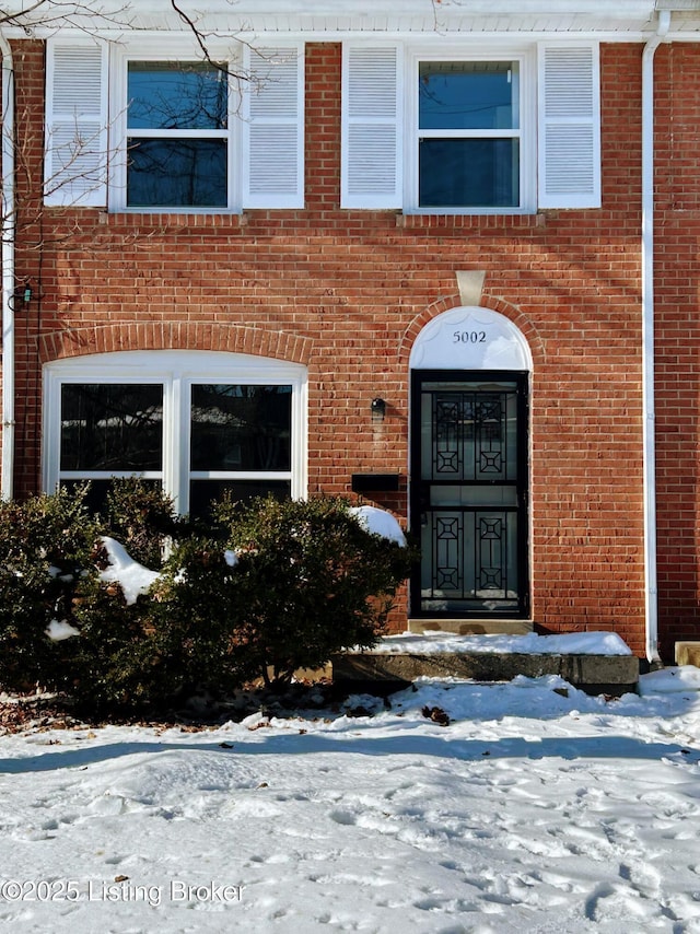 view of snow covered property entrance