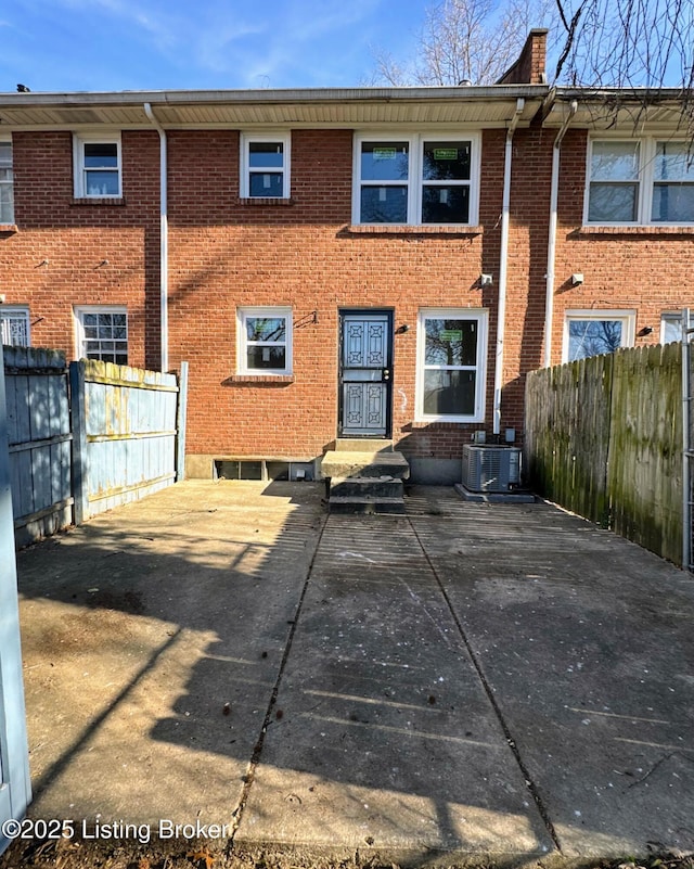 back of house with cooling unit and a patio