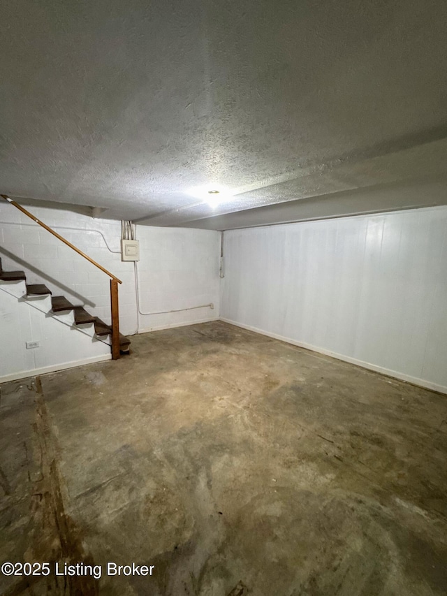 basement featuring a textured ceiling