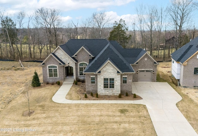 view of front of home with driveway, roof with shingles, and a front yard