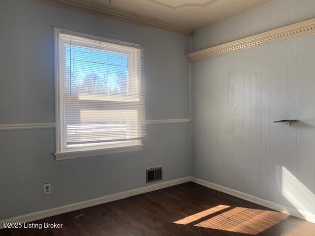 unfurnished room with plenty of natural light, dark hardwood / wood-style flooring, and crown molding