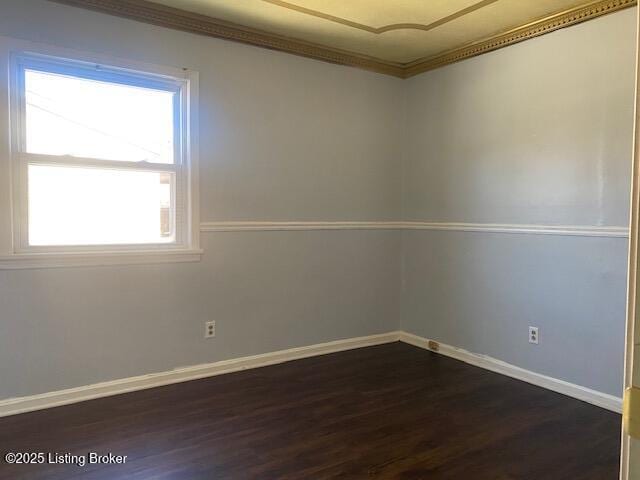 unfurnished room with a healthy amount of sunlight, dark hardwood / wood-style flooring, and crown molding